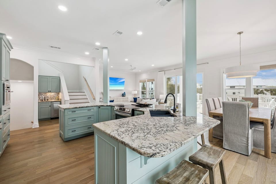 Your spacious open-concept kitchen features granite countertops, coastal-inspired cabinetry, and flows seamlessly into the living area for effortless entertaining.