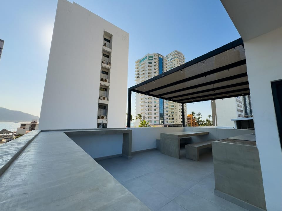 Spacious rooftop terrace with city views and built-in grill