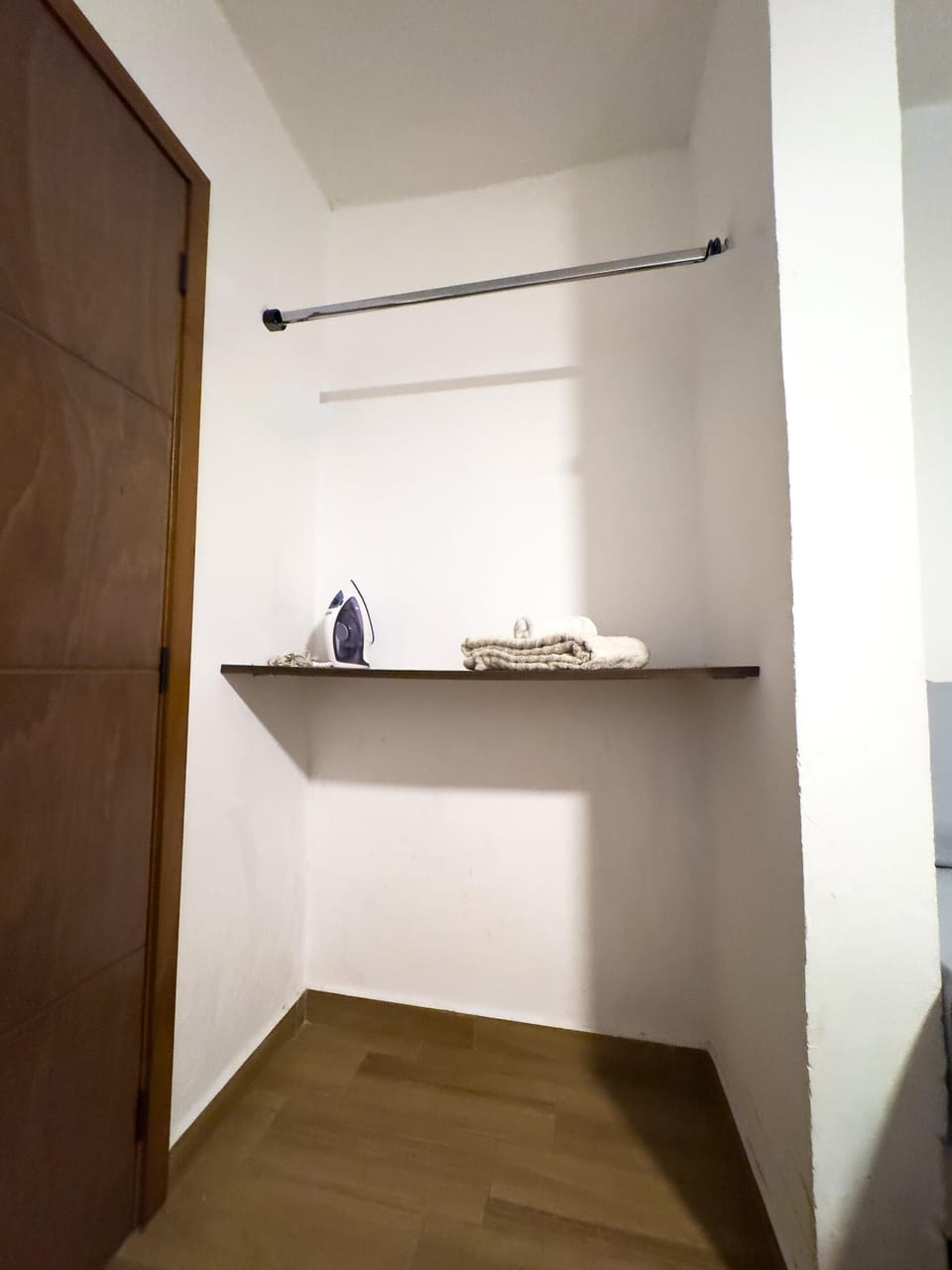 Cozy nook with sleek floating shelf and warm wood flooring