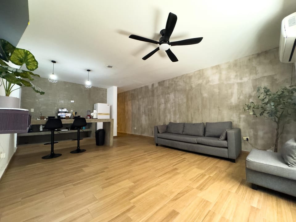 Spacious living room with modern concrete accent wall and sleek design