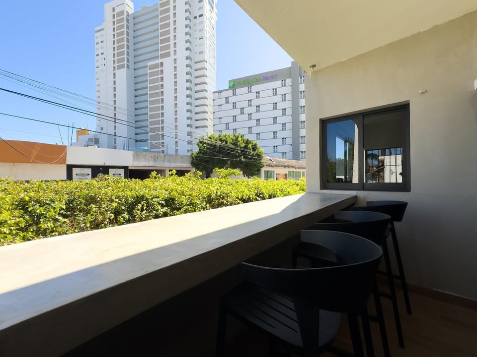 Cozy balcony retreat with city skyline views and seating