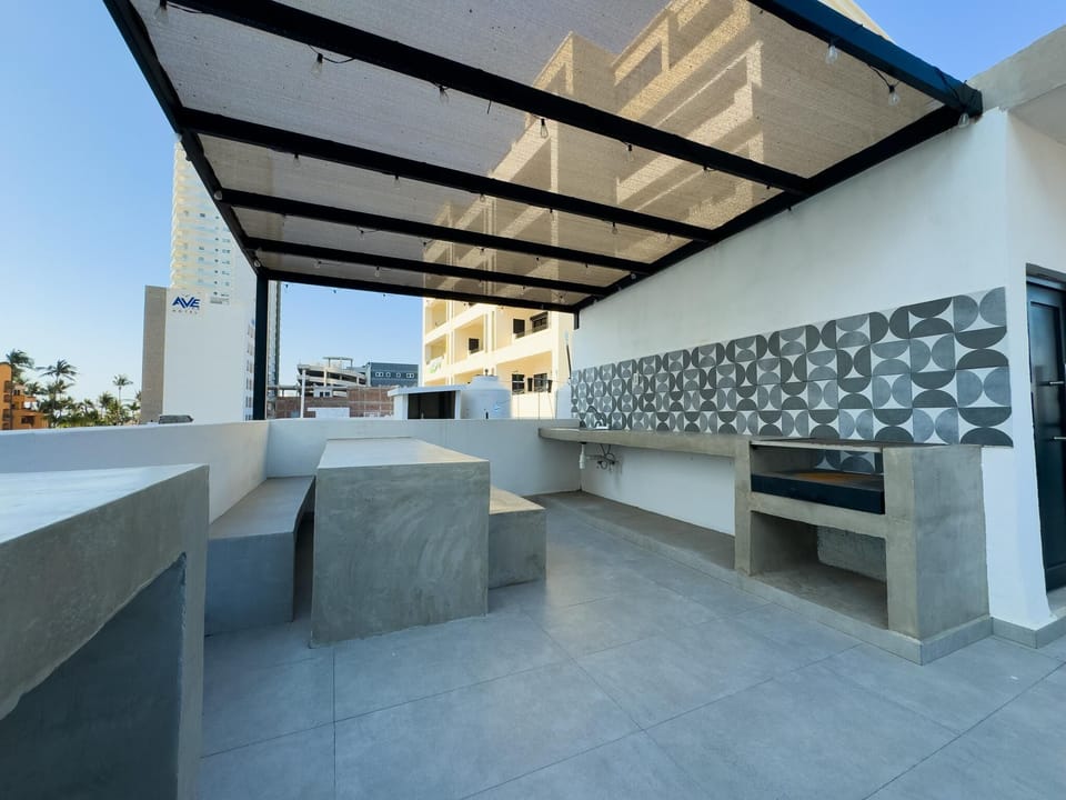 Sleek outdoor kitchen and dining area with modern design
