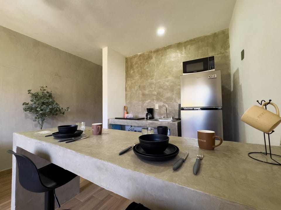 Modern kitchen with sleek concrete countertops and cozy dining nook