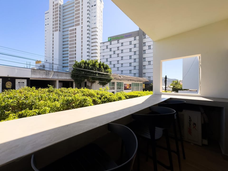 Cozy balcony retreat with cityscape views and seating