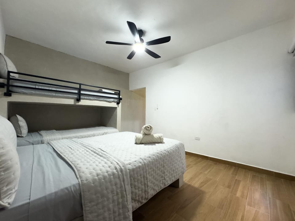 Cozy bedroom retreat with modern bunk bed and ceiling fan