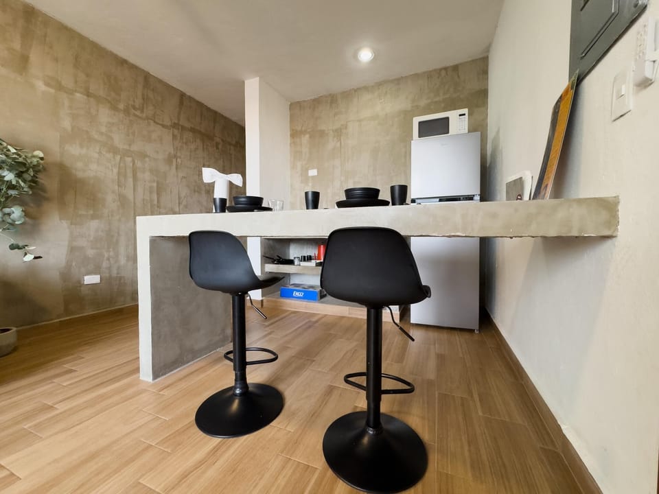Modern kitchen with sleek concrete countertops and cozy seating