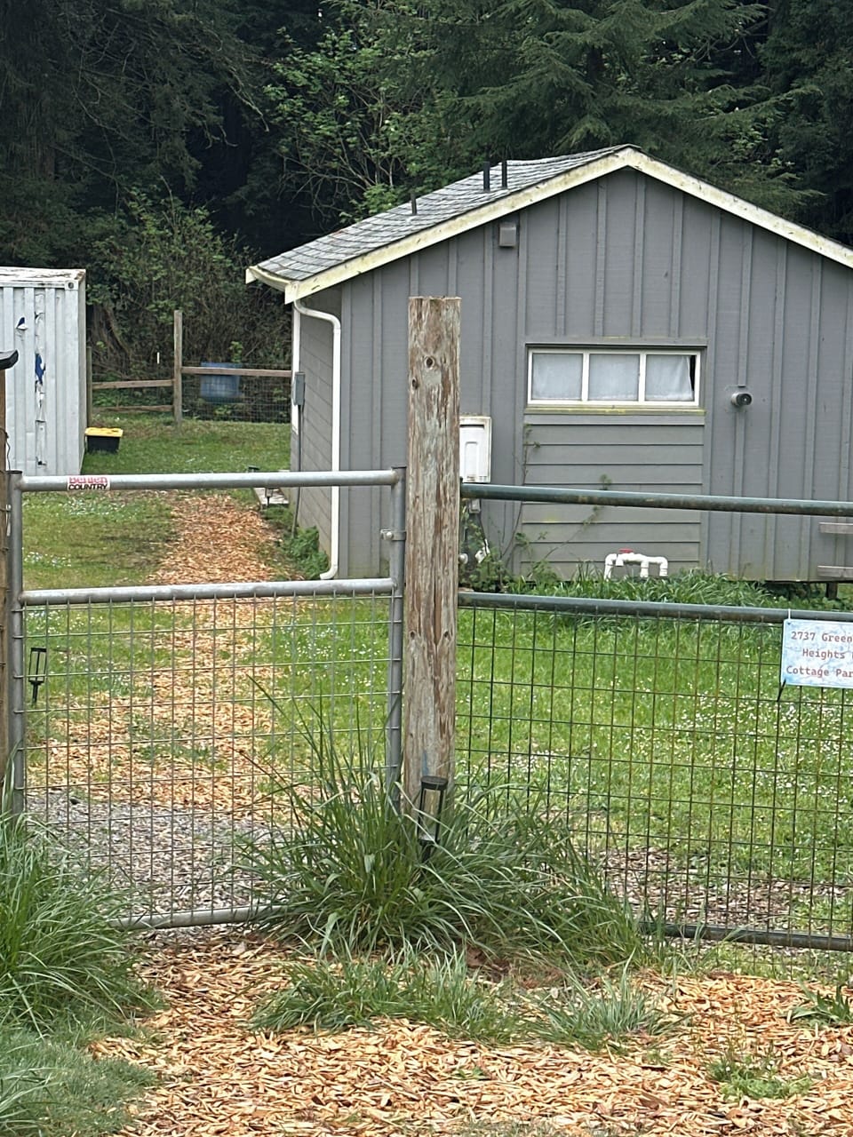 Parking area in front of the double gate. Path to the front door