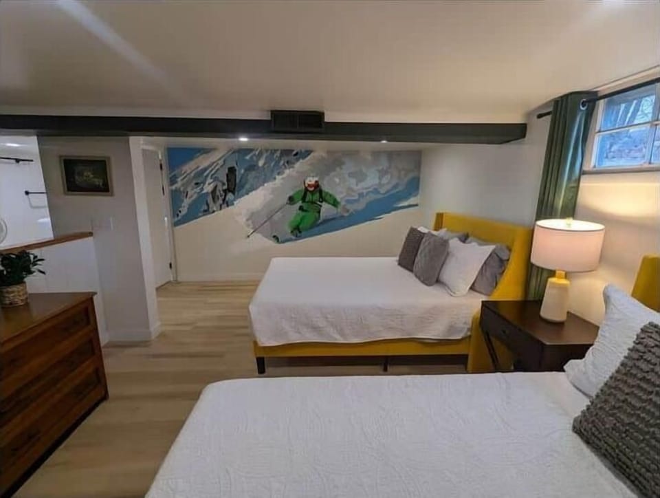 Bedroom with two queen beds and custom mural