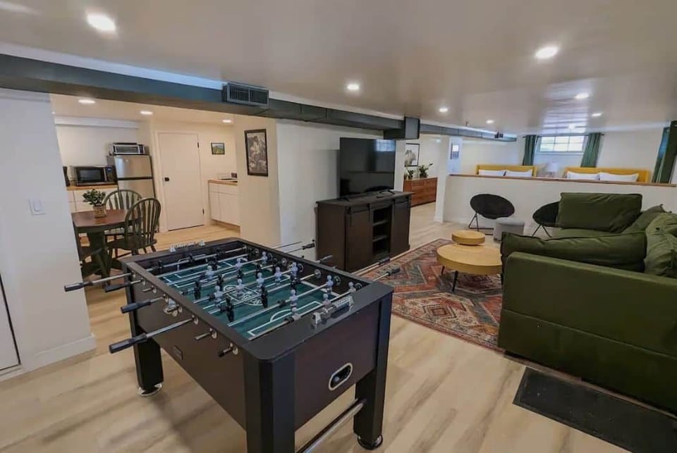 Living room with foosball table and kitchen