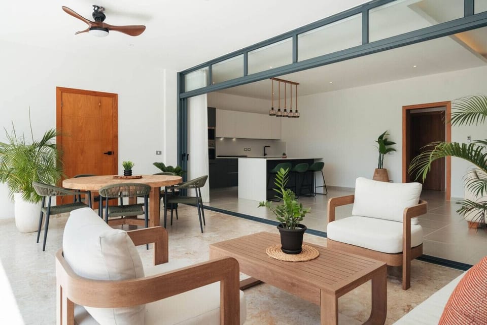 Relaxed lounge area on the balcony, set up for easy indoor-outdoor living. Slide the doors open and move between the kitchen, dining, and seating space without missing the breeze.