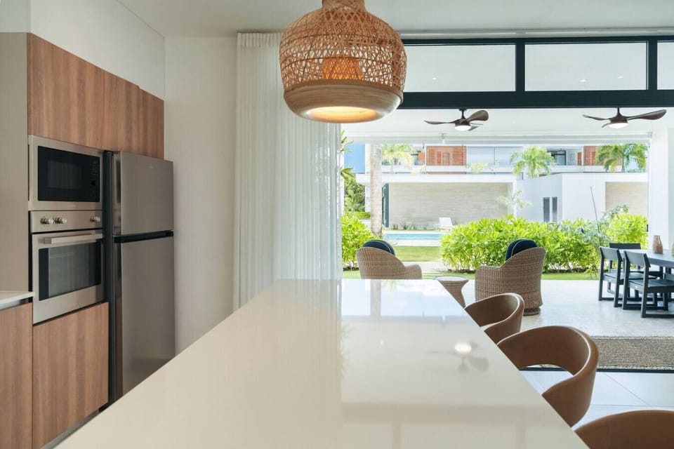Kitchen island with seating and a view out to the patio—great for morning coffee or keeping things social while cooking.
