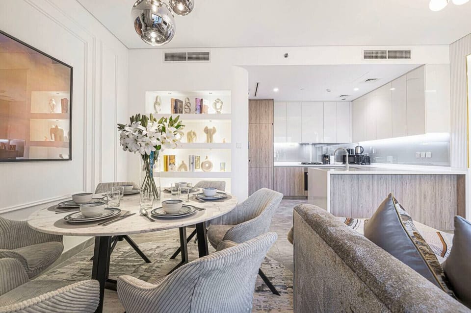 Elegant dining area with a sleek open kitchen and modern décor.