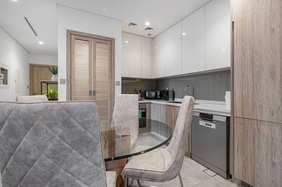 Modern open kitchen with sleek finishes and a cozy dining area—perfect for enjoying home-cooked meals.