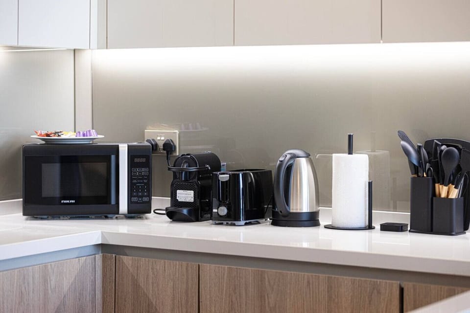 Fully equipped kitchenette with microwave, Nespresso machine, toaster, kettle, and all essential utensils—perfect for easy meals and morning coffee.