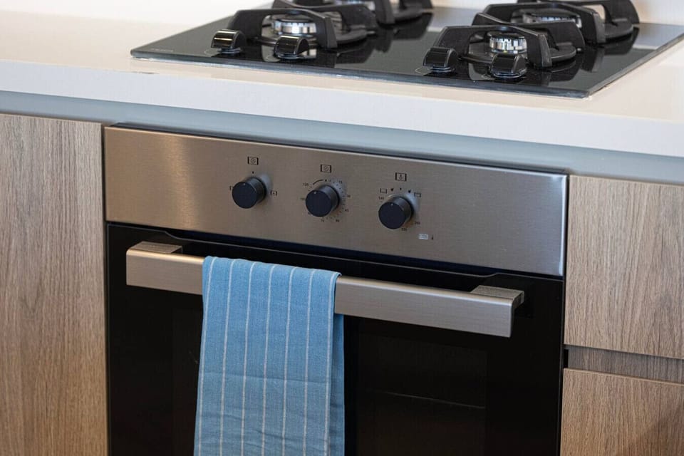 Modern, fully equipped kitchen featuring a sleek gas cooktop and stainless-steel oven—perfect for preparing meals during your stay.