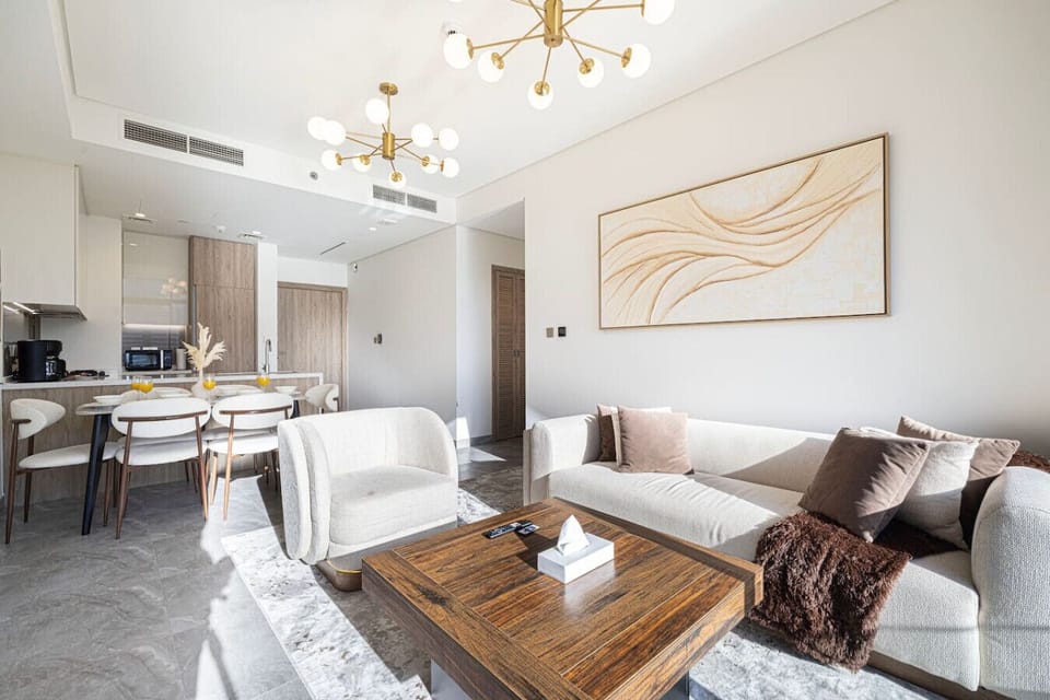 ✨ Chic open-plan living with cozy seating, warm tones, and elegant finishes — a bright, relaxing space to unwind after a day in the city. 🛋️🌤️