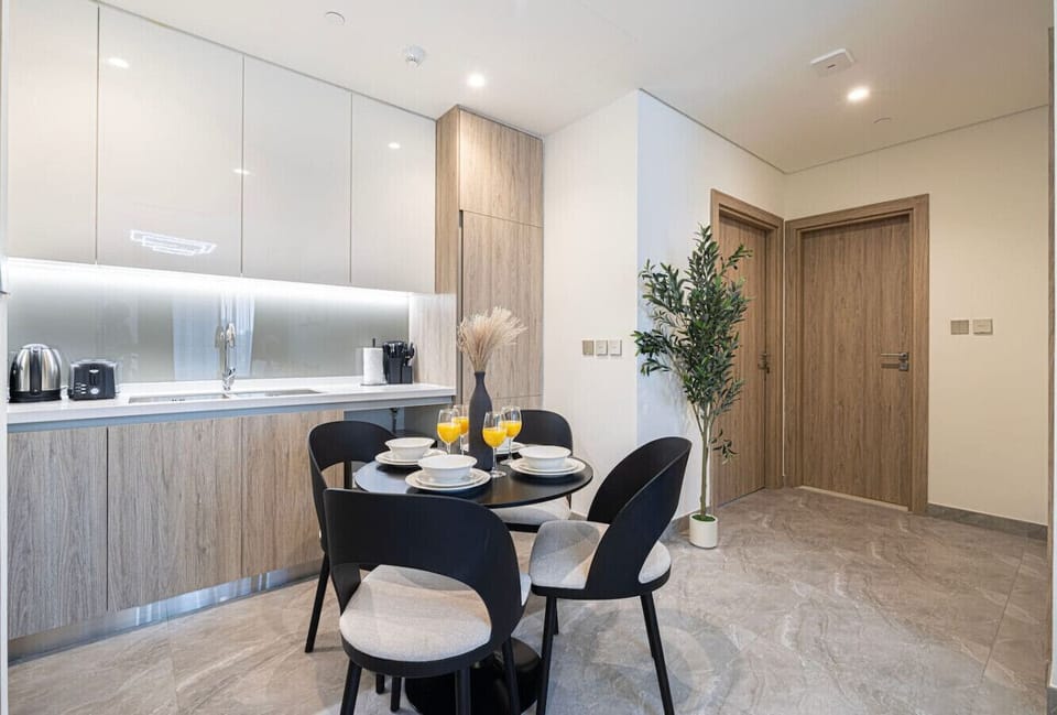 Sleek, fully equipped kitchen with a stylish dining area ready for shared meals and easy living