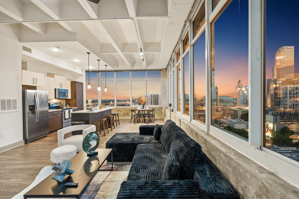 Experience breathtaking skyline views from every angle in this expansive open living space. Relax on plush seating, stream your favorites, and enjoy elevated city living day or night.