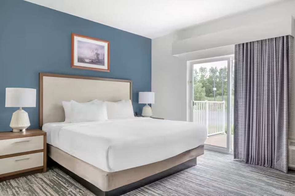 Unwind in crisp linens with fresh air balcony access.