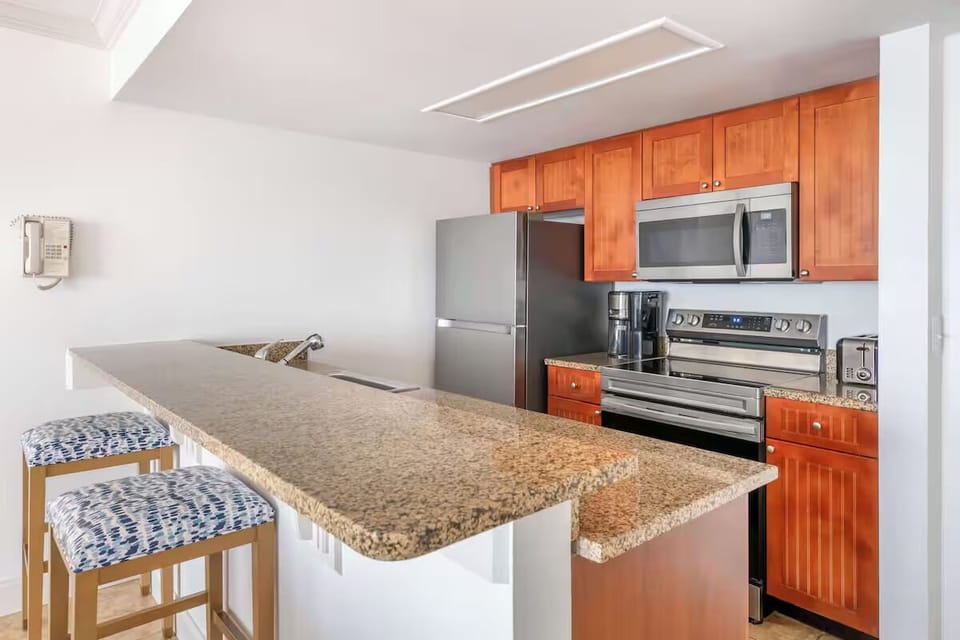 Cook vacation favorites in a full kitchen with granite counters.