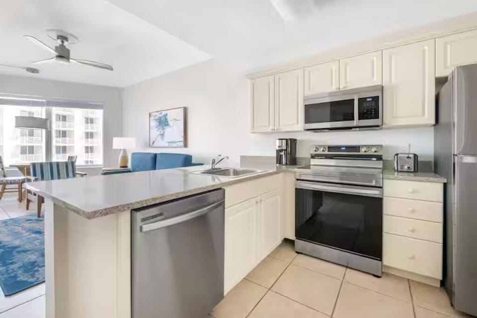Prep breakfast on generous counters with modern stainless appliances.