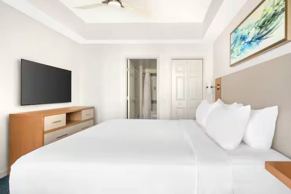 Settle into a spacious bedroom with soft lighting and serenity.