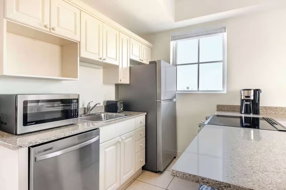 Cook simple meals with a clean, well-equipped kitchen setup.