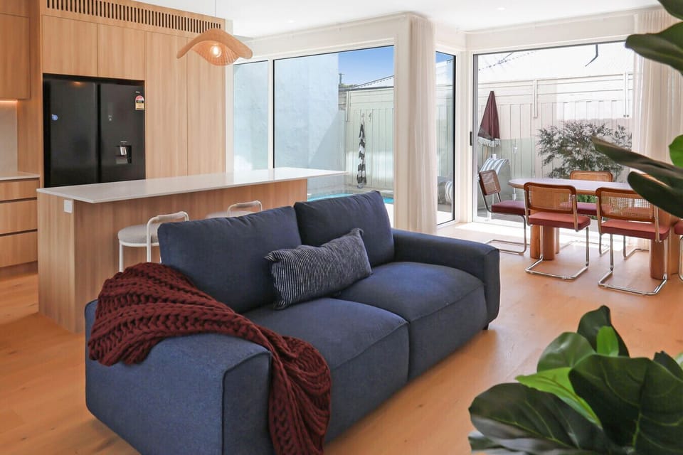Open-plan living with kitchen, dining, and seamless access to the courtyard.