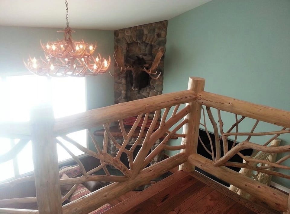 From 2nd fl loft showing the 2-story tall stone fireplace & "Elmer the Moose"