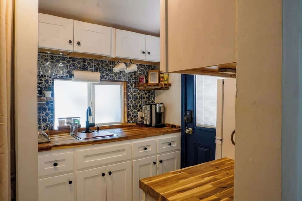 Compact kitchenette with essential appliances and everything needed for quick meals or snacks.