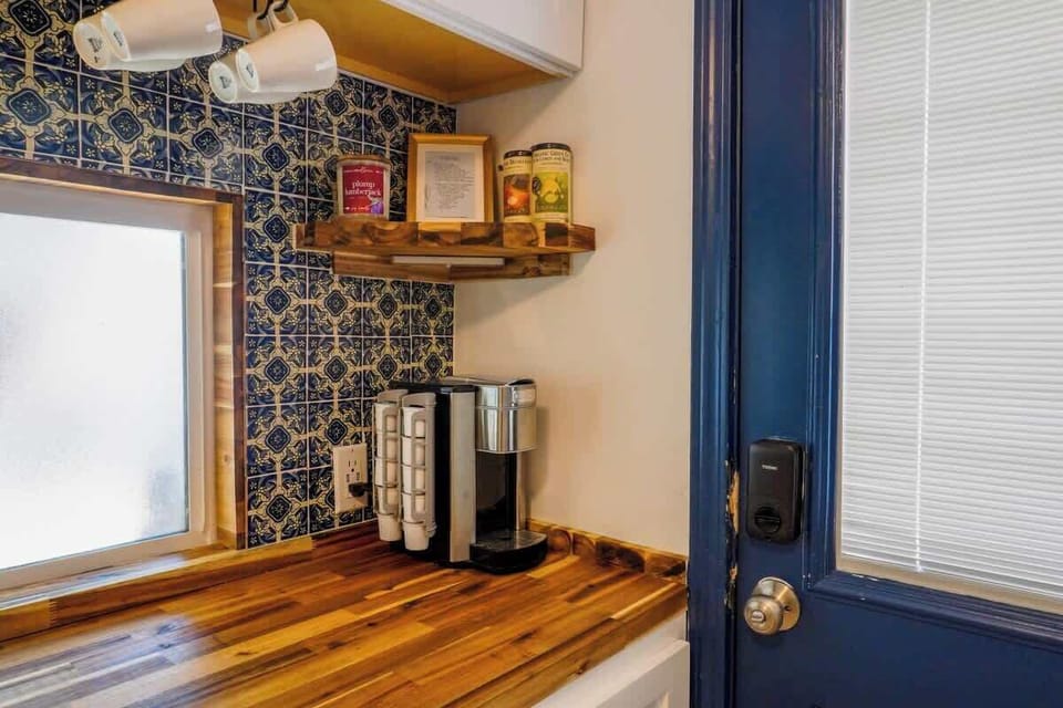 Compact kitchenette with essential appliances and everything needed for quick meals or snacks.