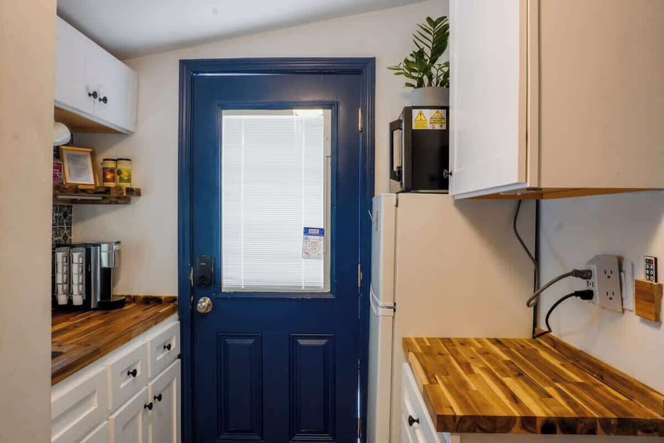 Compact kitchenette with essential appliances and everything needed for quick meals or snacks.