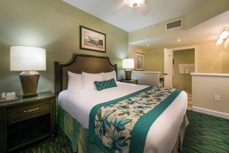 Stretch out in a spacious bedroom with warm bedside lamps.