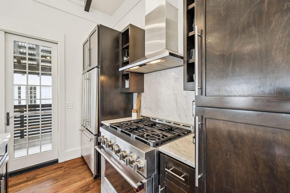 Gourmet kitchen with stainless steel appliances and natural light