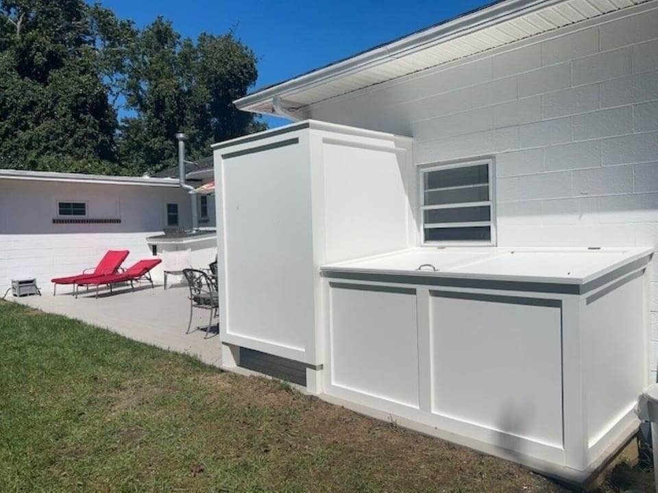 Outdoor shower and deck box with chairs and boogie boards