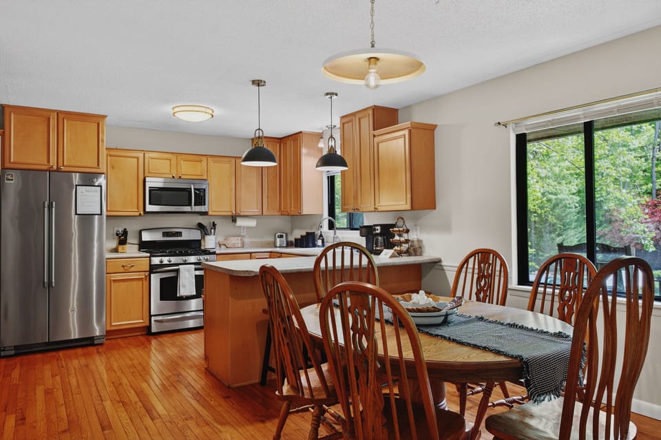 Large kitchen with updated lighting and appliances