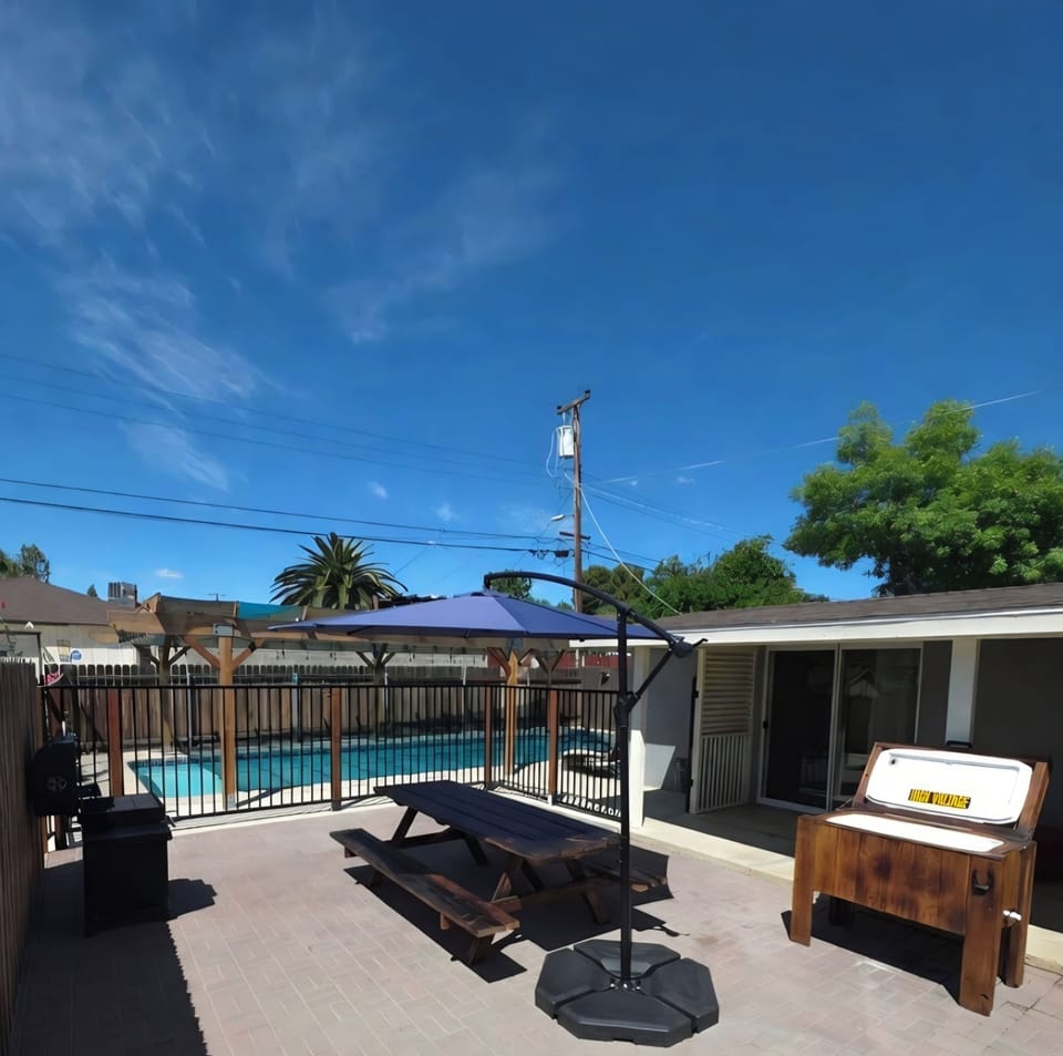 Patio includes picnic table, umbrella, Grill, and Ice chest.