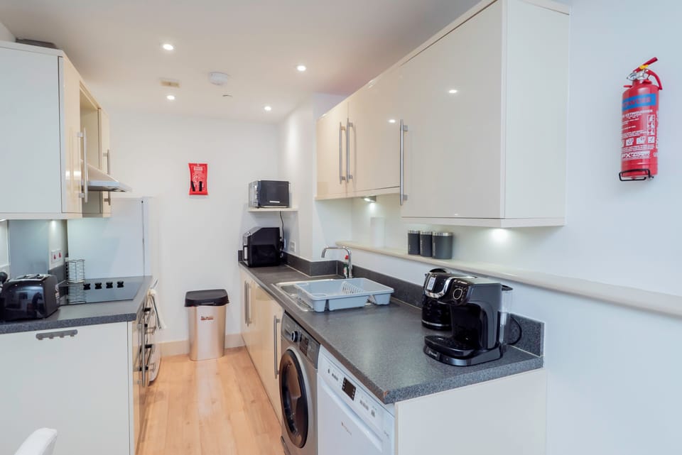 Fully equipped modern kitchen with oven, microwave,air fryer, kettle, coffee machine, and all the essentials for home cooking.