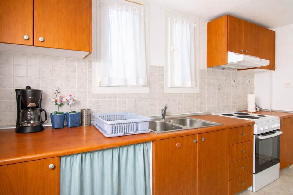 Functional kitchen area featuring essential appliances and storage, offering everything needed for a convenient and comfortable stay