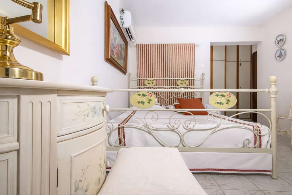 Charming bedroom corner showcasing classic décor, soft tones, and gold details