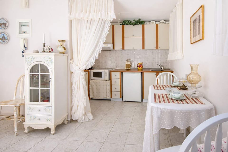 Cozy living and kitchen area with a warm, homey feel. The space blends functionality and charm, featuring a compact kitchen dining corner, and a relaxing ambiance perfect for everyday comfort