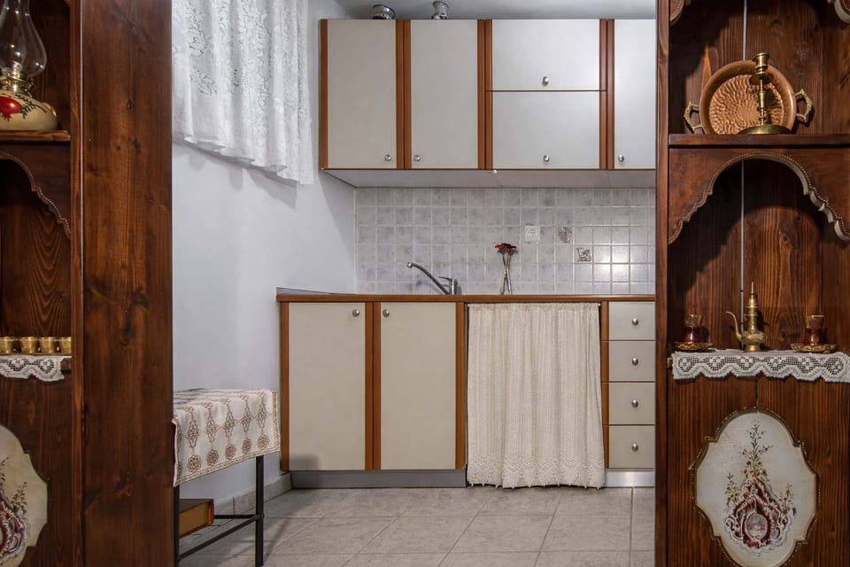 Compact and functional kitchen with essential appliances and storage, perfect for preparing simple meals during your stay