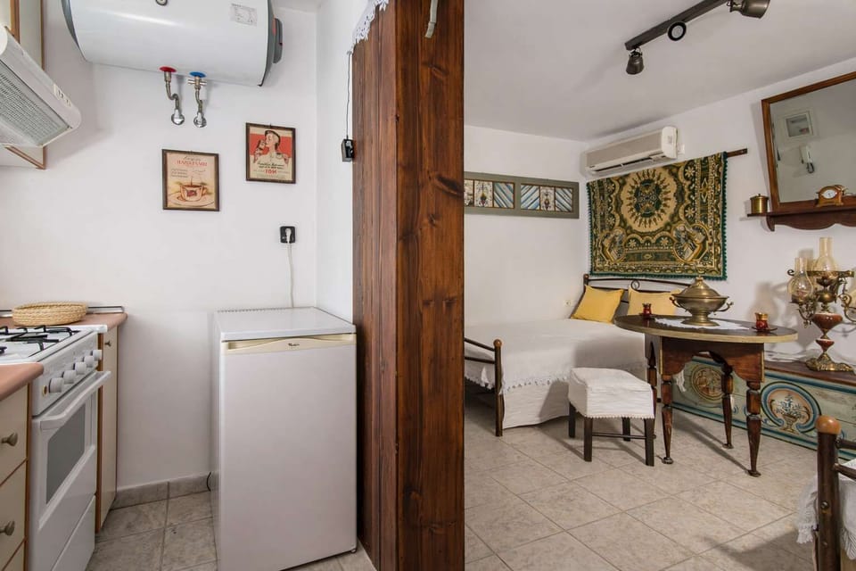 Open-plan layout combining kitchen, dining, and sleeping areas, designed for comfort and practicality in a traditional setting