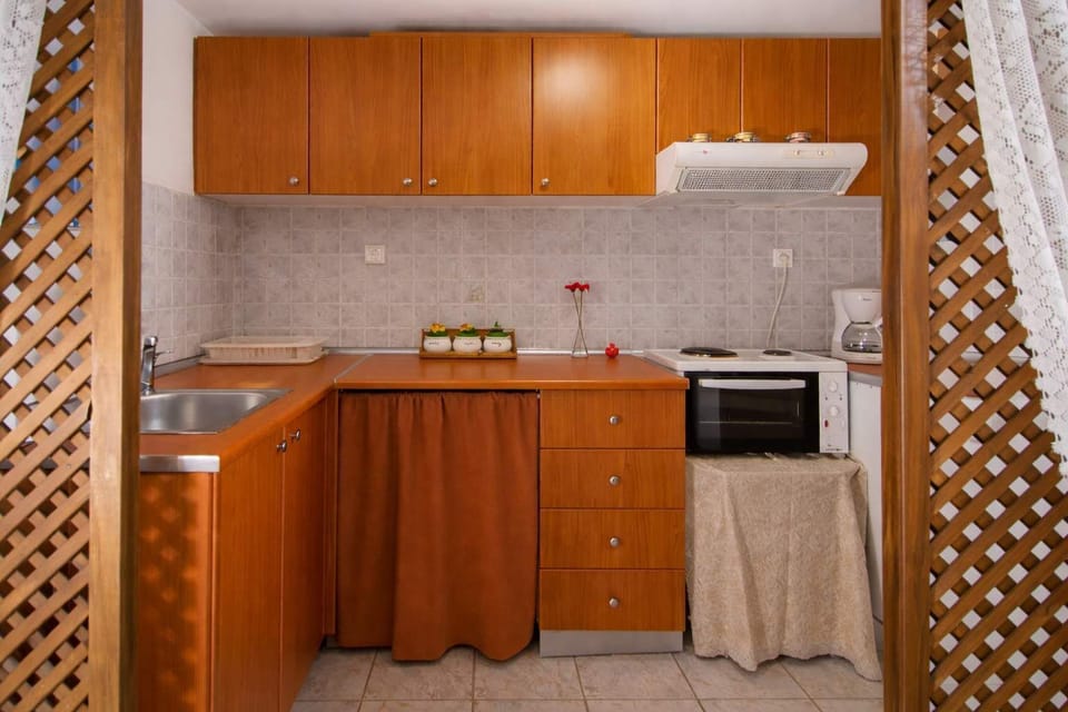 Compact kitchenette with essential appliances and storage, ideal for preparing meals during your stay