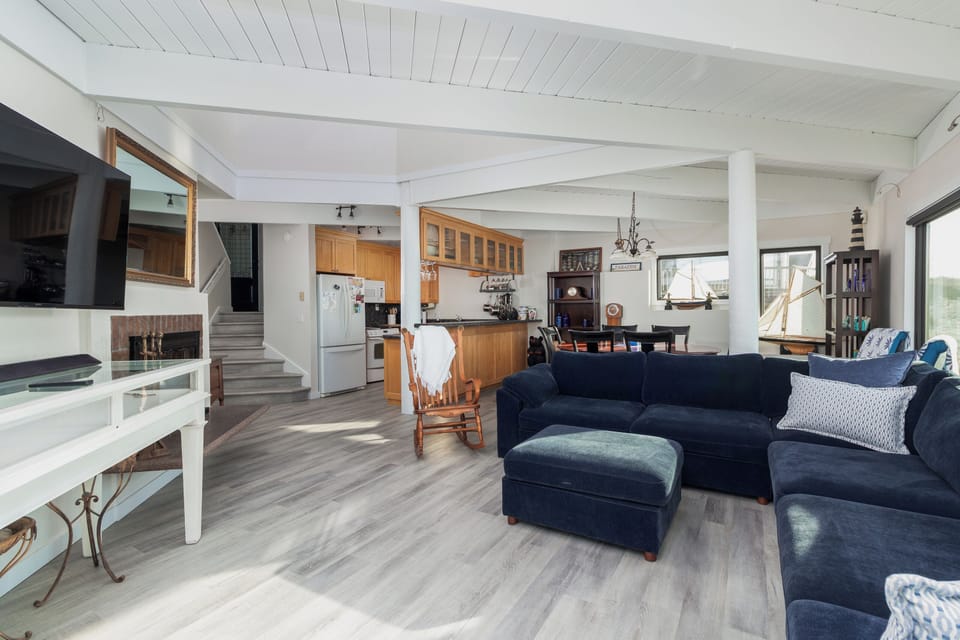 Relax in this bright, open living space where your cozy sectional faces the kitchen, perfect for conversations while cooking.