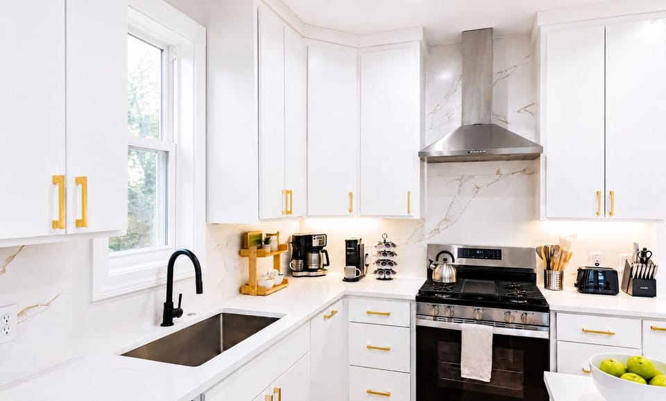 A deep undermount sink and ample counter space under soft natural light make meal prep a breeze in this beautifully organized corner.