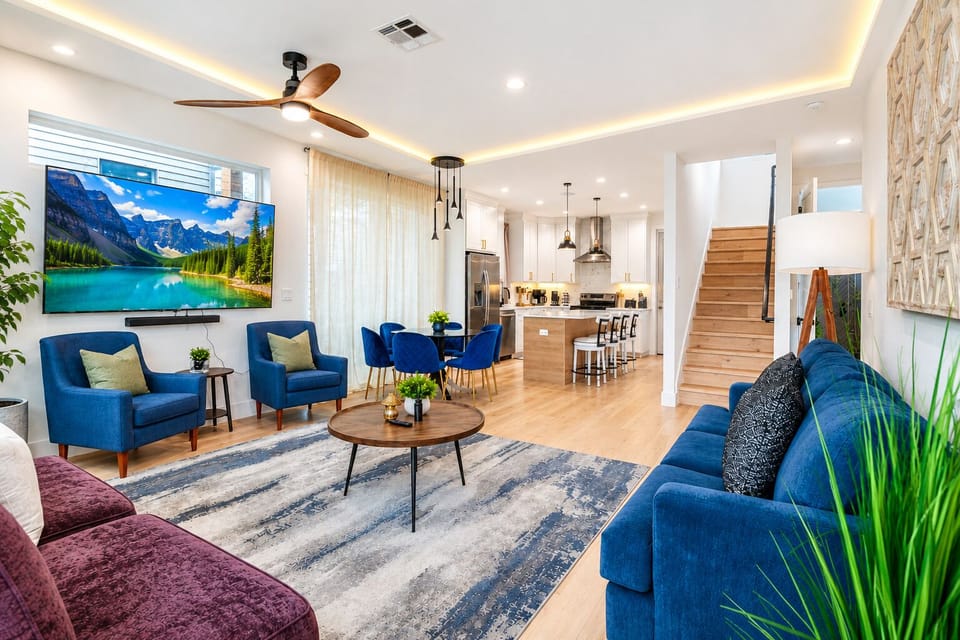 This bright, open-plan space seamlessly integrates stylish cobalt blue velvet seating with a modern dining area and a fully equipped chef's kitchen.