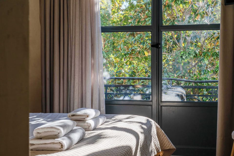 Bedroom with Large Glass Doors and Balcony View