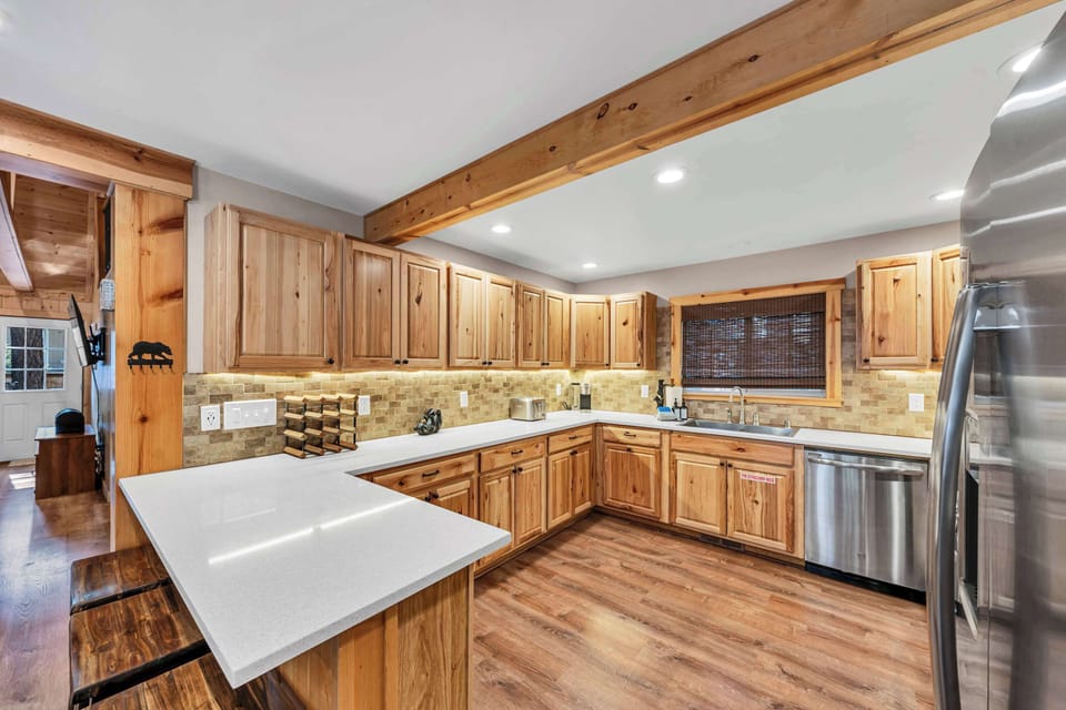 Kitchen: Breakfast bar with seating for 3, stainless steel appliances, drip coffee maker