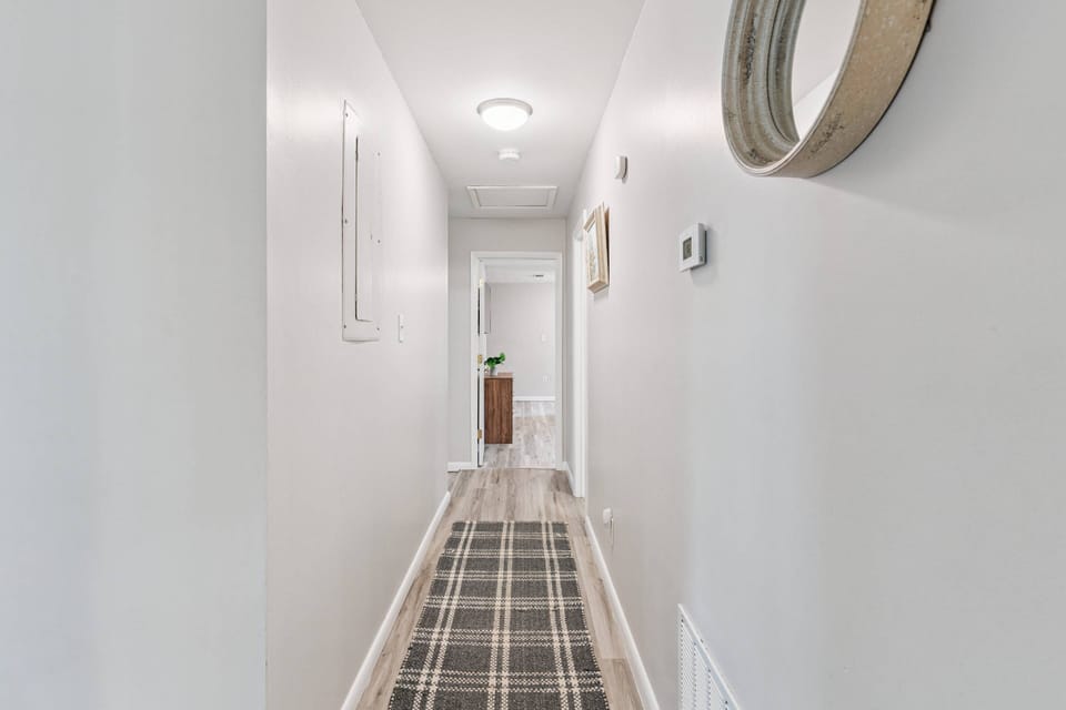 A long hallway separates the 3 bedrooms from the rest of the living spaces.